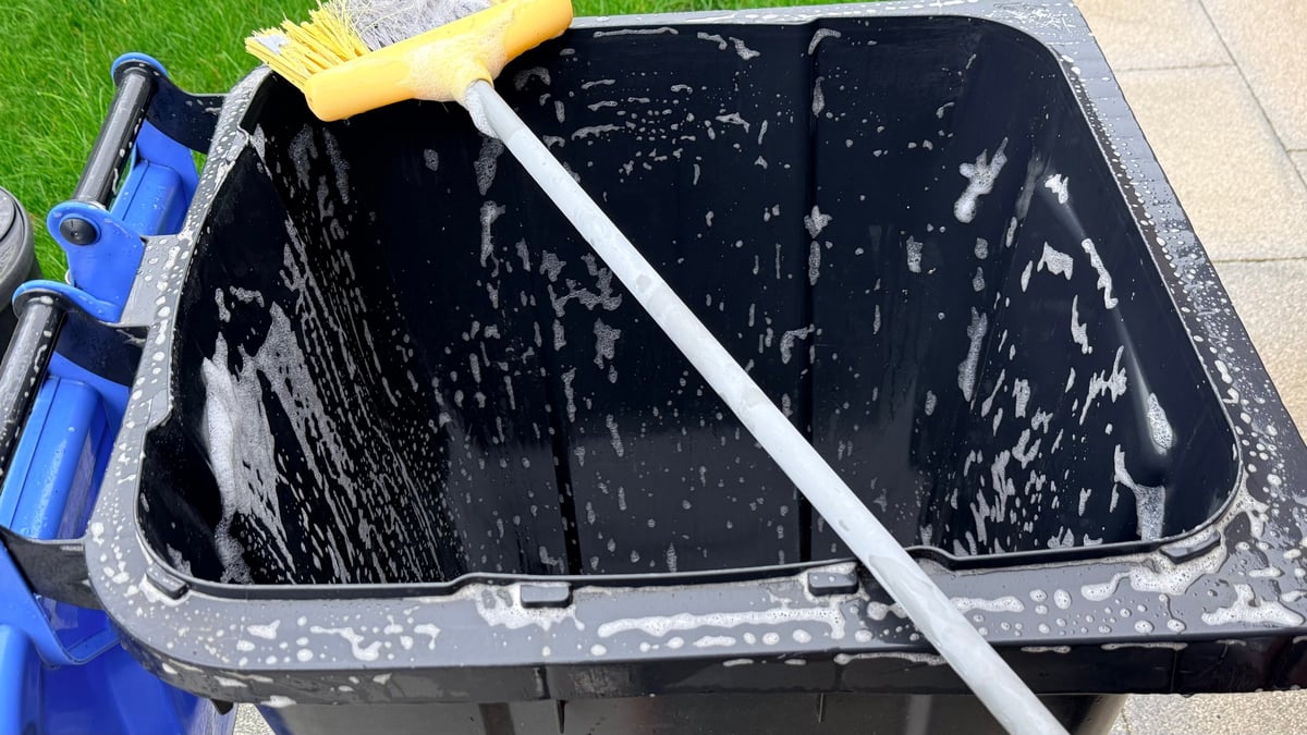 Trash bin being professionally cleaned and sanitized