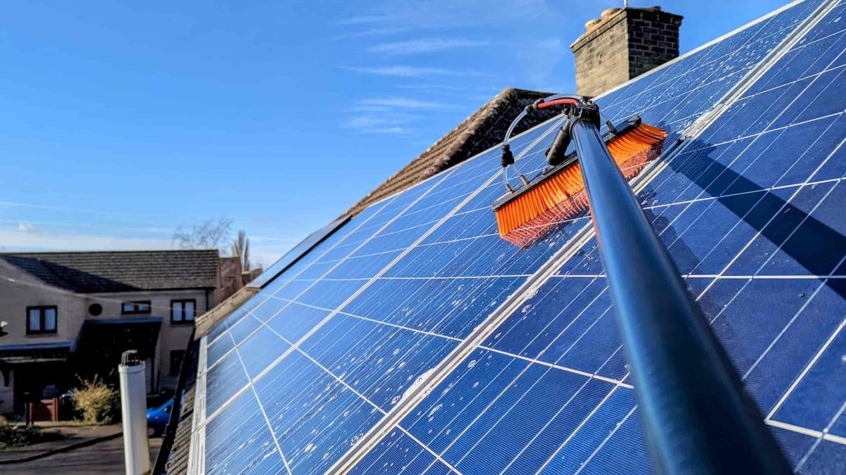 Krieger technician cleaning solar panels